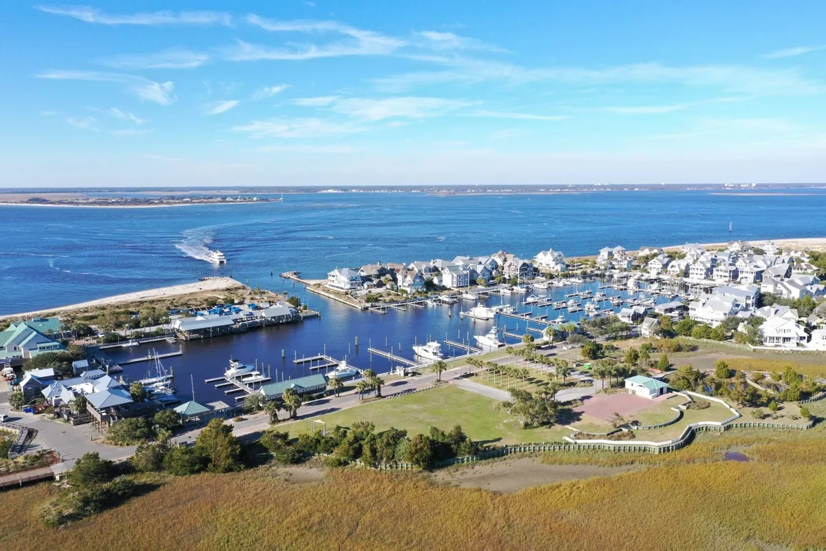 A lively marina scene featuring houses along the waterway, boats docked at slips, and green park spaces. The area buzzes with opportunities for boating, waterfront dining, and exploring the local neighborhood, all within easy reach of Doc House.